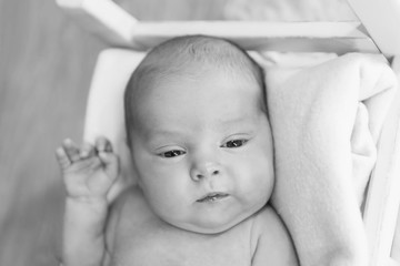 portrait of a little girl: baby's face with hand near the face close-up. concept of childhood, healthcare, IVF