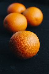 Oranges on black textured background.
