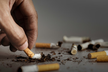 Hand extinguish cigarette.Cigarettes is addictive to be cancer.smoking reduction campaign in World...