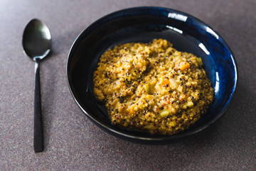 plant-based food, vegan creamy quinoa with cauliflower sauce and chopped celeri and carrots