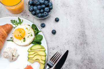 European Breakfast with croissant, avocado, salmon and cottage cheese. Drinks for Breakfast.
