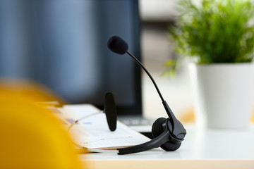 Empty remote office workplace with laptop pc and headset closeup. Receptionist or secretary of...