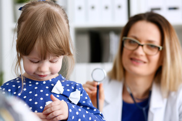 Little child with stethoscope at doctor reception. Physical exam cute infant portrait baby aid healthy lifestyle ward round child sickness specialist clinic test pulse concept
