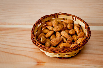 Almonds nuts shot large on a wooden background. Background for healthy eating and vegetarianism.