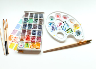 Set of watercolor paints, art brushes and palette. Art creativity concept.