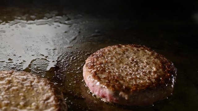 delicious beef burger patty for restaurant advertising. on a black dark background for bbq concepts
