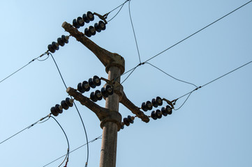 electricity distribution pole with black glass insulators