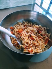 Noodles in a steel bowl.