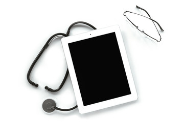 Digital tablet with stethoscope and glasses isolated on white. Top view, copy space. Medicine concept.
