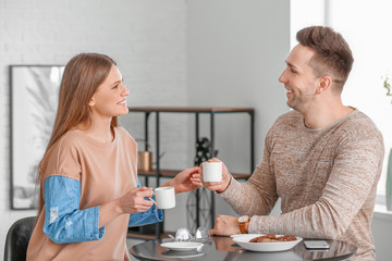 Young couple drinking coffee in cafe