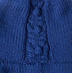 Knitted background. Knitted texture. A sample of knitting from wool. Knitting Pattern.