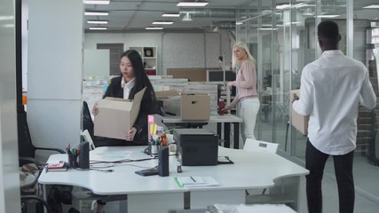 International office, office workers managers return from remote work to the office, the end of the quarantine, workers takes things out of cardboard boxes and prepare work places for work.