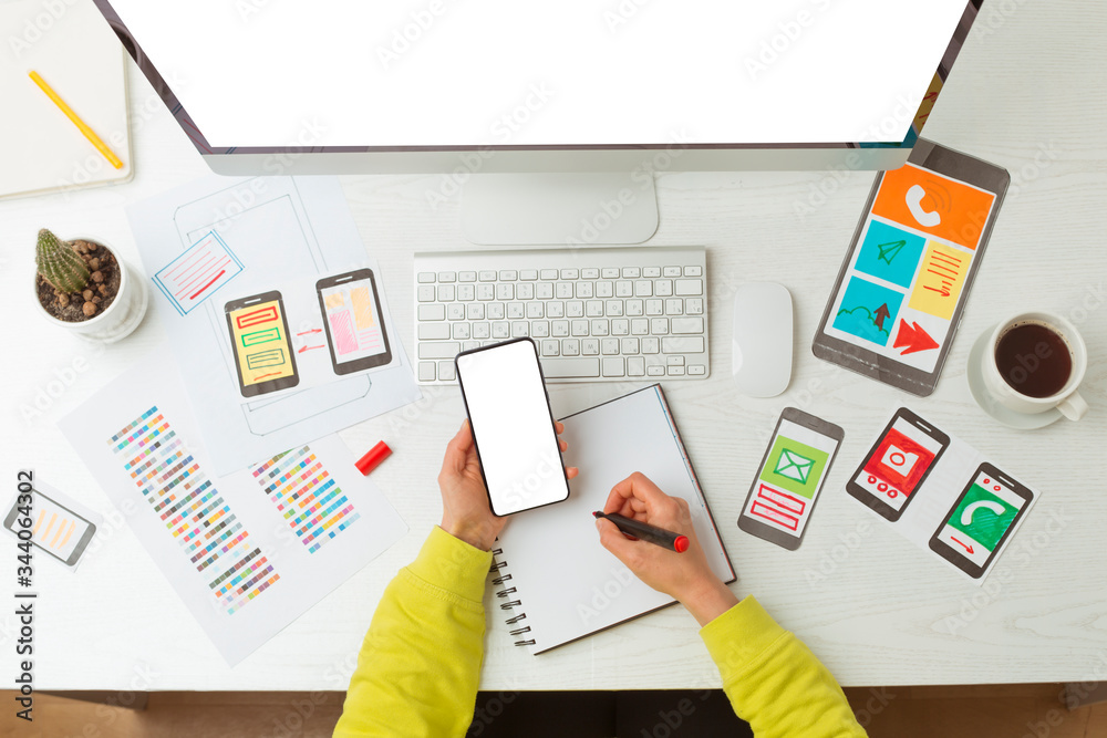 Poster web designer mobile phone application developer. top view of the desktop of the creator of the sketc