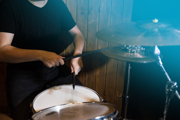 
Professional drum set closeup. Man drummer with drumsticks playing drums and cymbals, on the live...