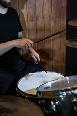 
Professional drum set closeup. Man drummer with drumsticks playing drums and cymbals, on the live...