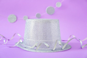 Party hat and decor on color background