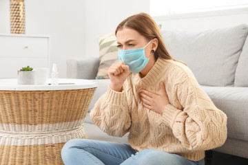 Sick woman in protective mask at home. Concept of epidemic