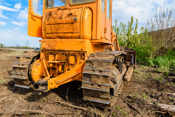 Industrial building construction site bulldozer leveling and moving soil during highway building