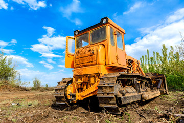 Industrial building construction site bulldozer leveling and moving soil during highway building