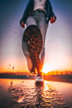 Woman Kicking Water To The Camera