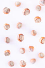 Falling hazelnuts on colored background, selective focus. Top view, flat lay
