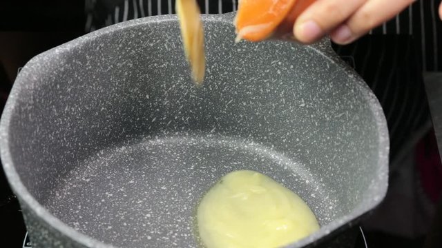 Melting of Desi ghee or clarified butter in a hot pan.