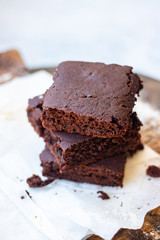 Baked chocolate vegan dessert. Homemade brownie cake with  sweet cream spread. 