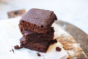 Baked chocolate vegan dessert. Homemade brownie cake with  sweet cream spread. 