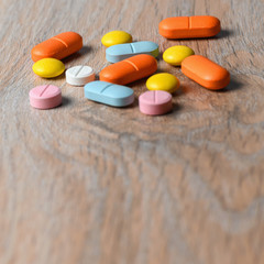 Assorted color tablets close-up on the table. Concept of protection and treatment of coronavirus infection. Copy space.