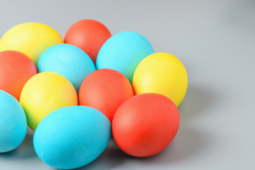 Colorful Easter eggs on a gray background. Easter eggs background. Easter eggs are a symbol and a mandatory attribute of the holiday.