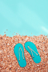 Concept of beach holiday. Sand Beach and and summer flip-flops with sunlight on abstract sea....