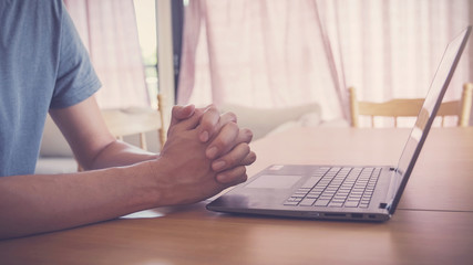 Praying hands with laptop,  worship online at home, streaming online church service, social...