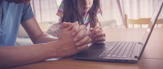 praying hands, family praying with laptop, and parent and kid worship online together at home,...