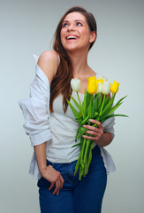 Happy woman holding tulips flowers and looking away