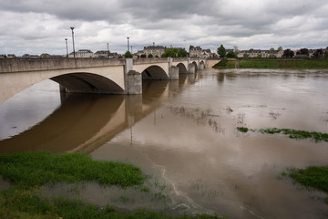 Fototapeta na wymiar Bridge across a swollen Loire River at Saumur, France