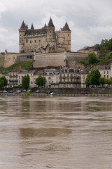 Fototapeta na wymiar The chateau across a swollen Loire River at Saumur, France