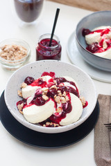 Cottage cheese pancakes with berry sauce and nuts. Healthy breakfast concept.