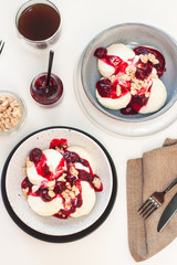 Cottage cheese pancakes with berry sauce and nuts. Healthy breakfast concept.