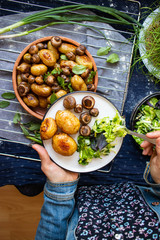 Vegan balanced assorted vegetables mix food. Young roasted potato, green salad, baked mushrooms.