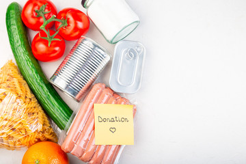 Food  for donation or delivery at home, note with word donation, horizontal, top view, copy space