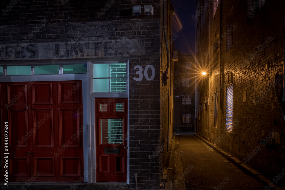 Wall mural ghost sign and old alley at night