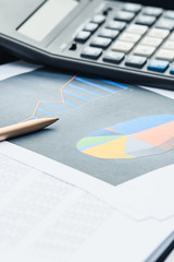 Obraz premium Business financial documents, office calculator and pen on the table. Numbers and graphs