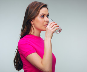 portrait of woman drinking water from glass.