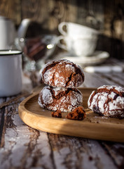 Marble cookies with cracks, a mug of coffee in the background.