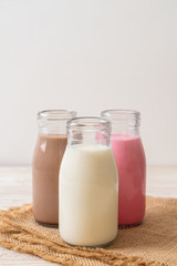 chocolate milk, pink milk and fresh milk in bottle