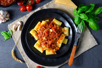 Rigatoni pasta with Bolognese sauce and fresh basil