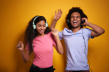 Fototapeta na wymiar Two cheerful African people in headphones