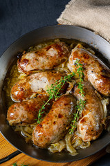 Homemade white sausage fried with onion and herbs
