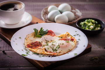 Fried eggs with green and vegetables. Helthy and delicious Breakfast.