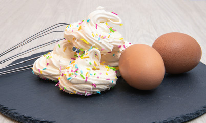 meringues with the ingredients to create them including eggs and sugar